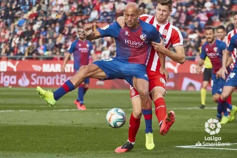 Mikel Rico protege el bal&oacute;n ante el acoso de un jugador del Girona. Foto: LaLiga