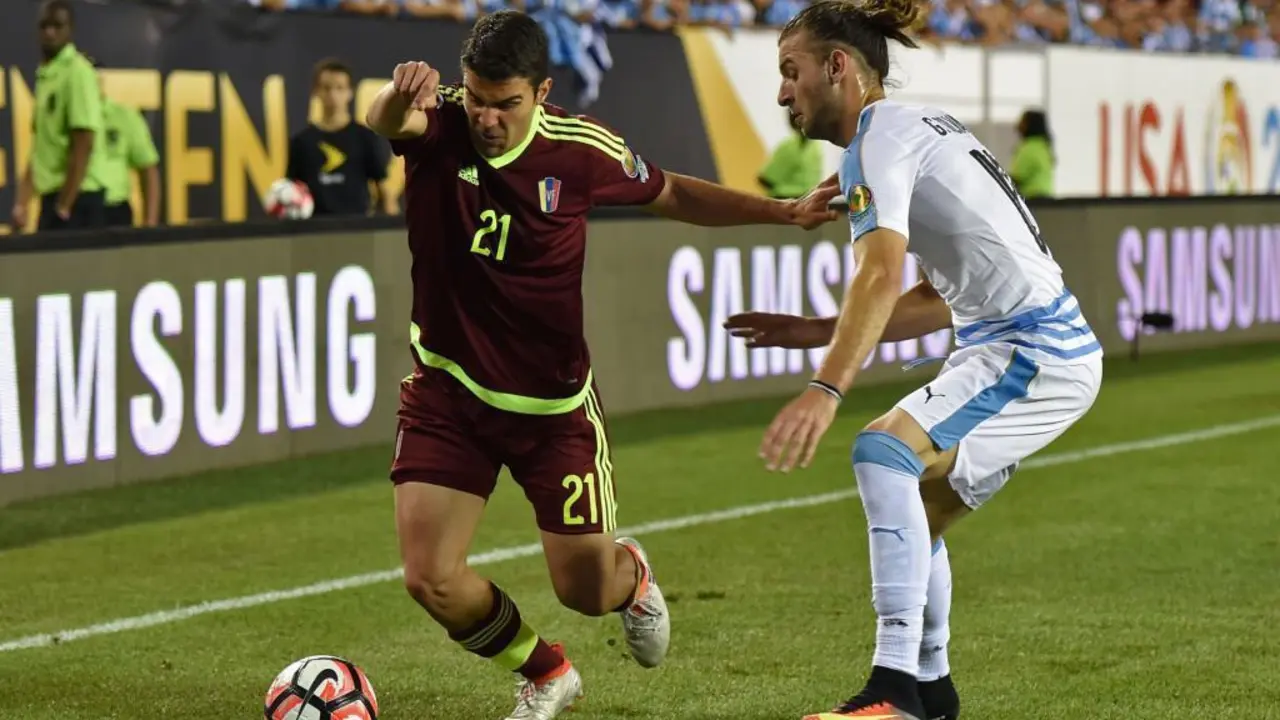 Venezuela's Alexander Gonzalez (L) is marked by Uruguay's Gaston Silva during the Copa America Centenario football tournament in Philadelphia, Pennsylvania, United States, on June 9, 2016.  / AFP PHOTO / DON EMMERT