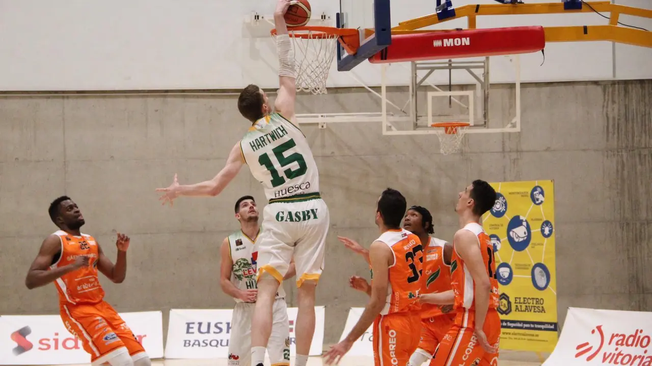 Philipp Hartwich se cuelga del aro tras un gran pase de Sans. Foto: CB Pe&ntilde;as Huesca