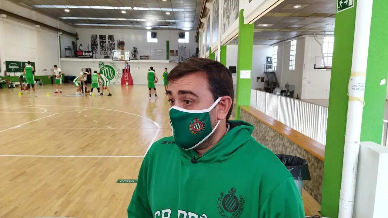 Sergio Lam&uacute;a, t&eacute;cnico del Levitec Huesca, en la rueda de prensa donde habl&oacute; del Almansa con sus jugadores calentando en el Pe&ntilde;as Center. Foto: Sportaragon