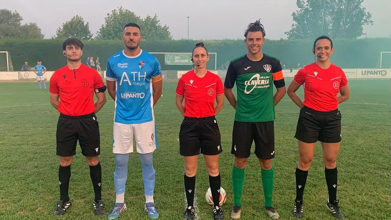 Foto de capitanes y cuerpo arbitral antes del inicio del partido.