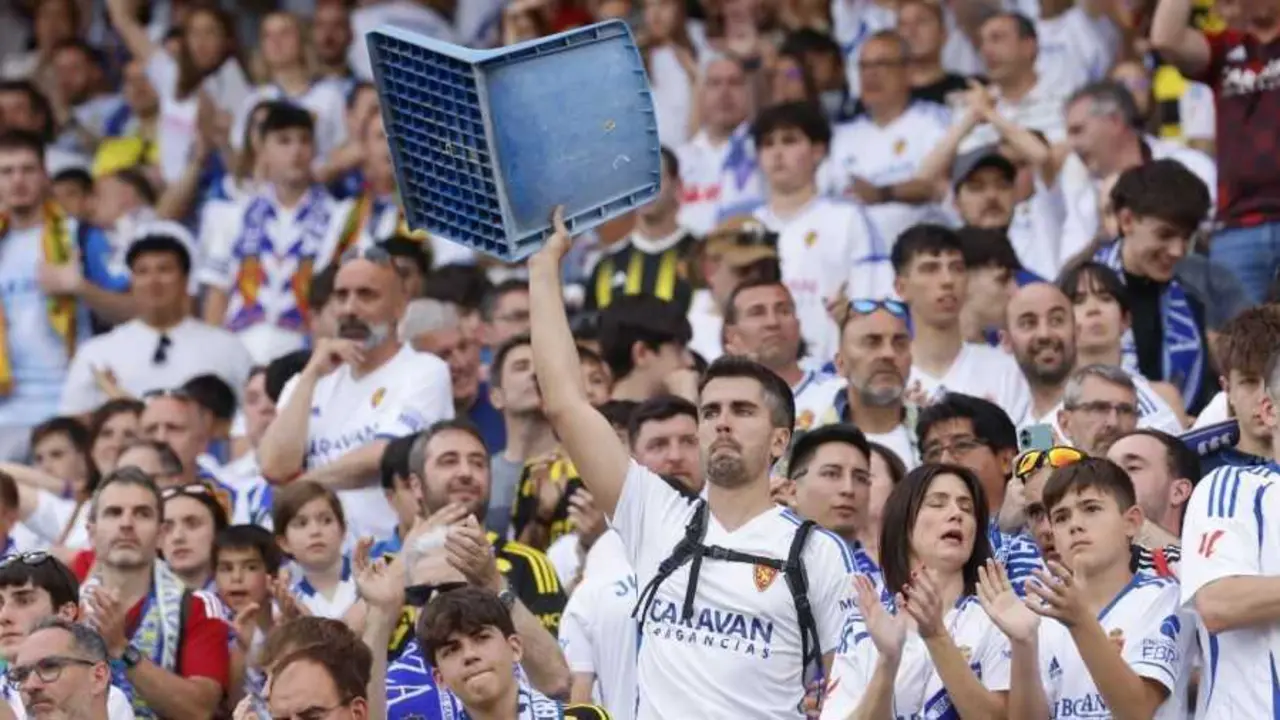 Aficionado sostiene una butaca de La Romareda / LaLiga
