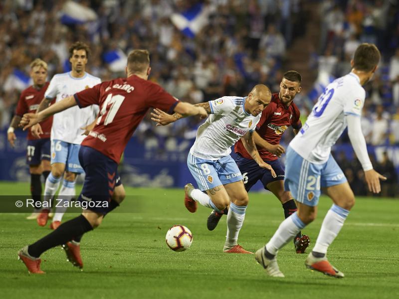 Pombo intenta conducir el balón ante los jugadores de Osasuna. | Foto: Tino Gil, Real Zaragoza